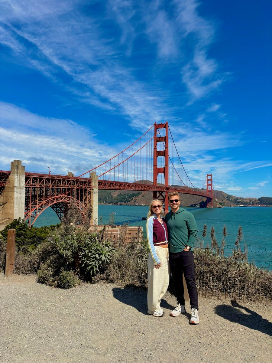 Rick and his wife in front of the Golden Gate Bridge